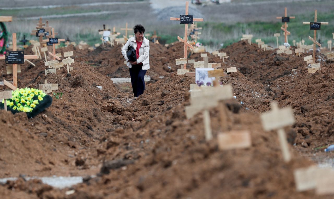 A woman named Tatyana searches for her husband's grave in the settlement of Staryi Krym, outside Mariupol, on May 15.  Zelensky says Russia waging war so Putin can stay in power &#8216;until the end of his life&#8217; 220516081522 01 ukraine gallery update