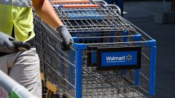 An employee gathers shopping carts at Walmart, July 22, 2020 in Burbank, California. 