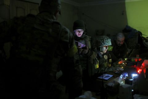 Ukrainian service personnel check information inside a basement used as a command post in a village retaken by Ukrainian forces in the Kharkiv region of Ukraine, May 15.