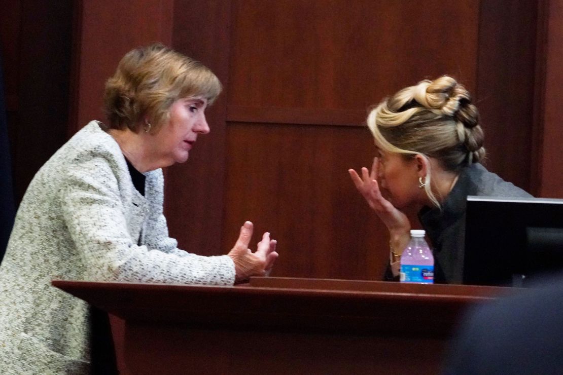 Amber Heard talks to her lawyer Elaine Bredehoft in the courtroom at the Fairfax County Circuit Courthouse on Monday.