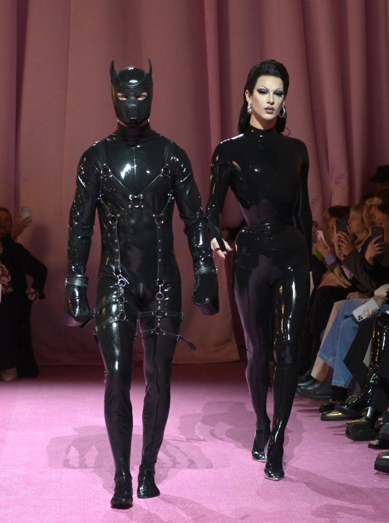Violet Chachki (right) walks down the runway with a submissive companion in tow at the 2022 Richard Quinn show during London Fashion Week.