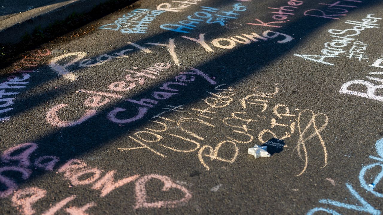 Victims names are written in chalk near the supermarket.