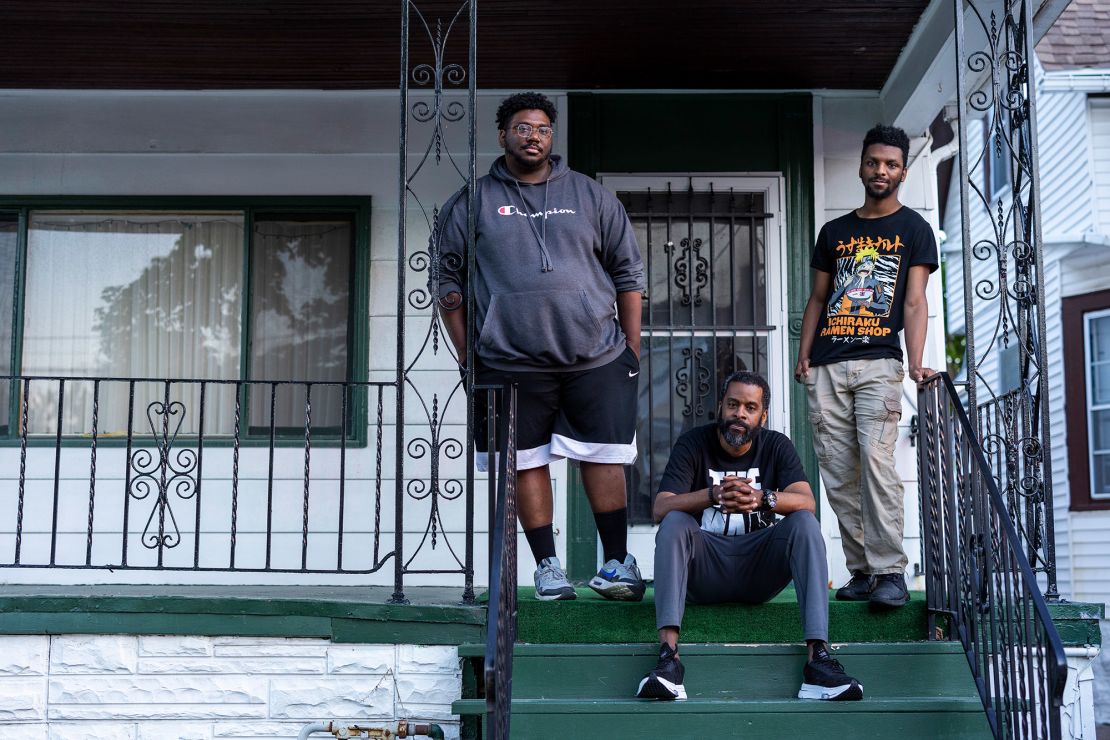 From left, Darious Morgan, Martin Bryant and Jordan Bryant stand on the steps of a family member's home, two doors down from Tops.