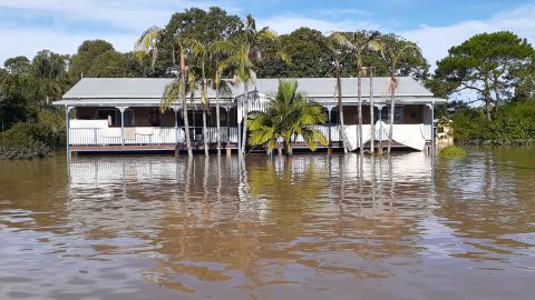 The water was high enough for Ken Morrison and his family to climb over the second balcony into his boat.