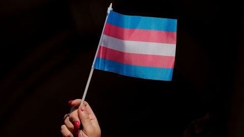 Someone holds up a flag during a rally to protest the Trump administration's transgender proposal at City Hall, New York.