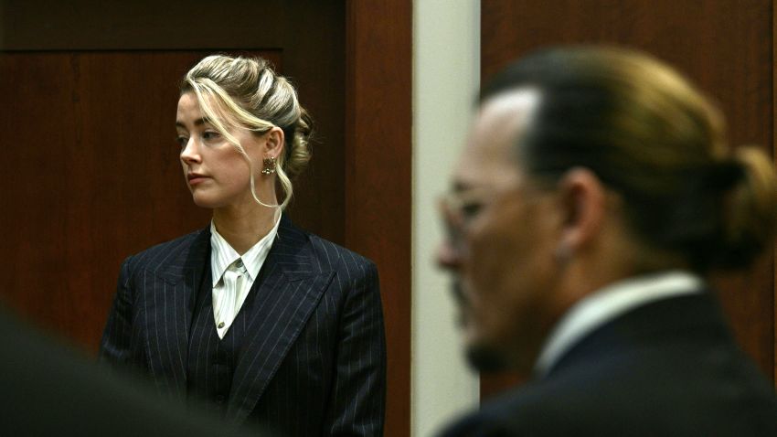 Actors Amber Heard and Johnny Depp watch as the jury comes into the courtroom after a lunch break at the Fairfax County Circuit Courthouse in Fairfax, Virginia, on May 17, 2022. - Actor Johnny Depp is suing ex-wife Amber Heard for libel after she wrote an op-ed piece in The Washington Post in 2018 referring to herself as a public figure representing domestic abuse. (Photo by BRENDAN SMIALOWSKI / POOL / AFP) (Photo by BRENDAN SMIALOWSKI/POOL/AFP via Getty Images)