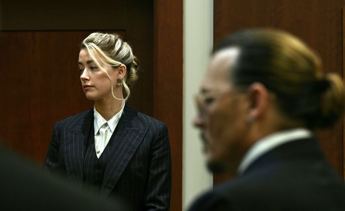 Amber Heard and Johnny Depp watch as the jury comes into the courtroom on Tuesday.