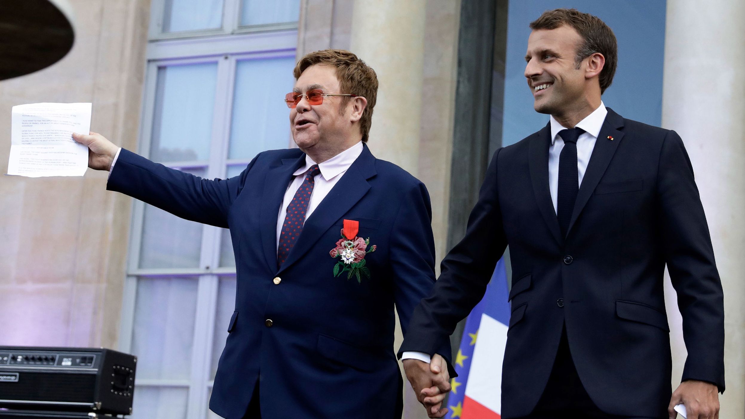 John and French President Emmanuel Macron arrive to speak to a crowd in Paris in June 2019. John was being honored with France's highest civilian award.