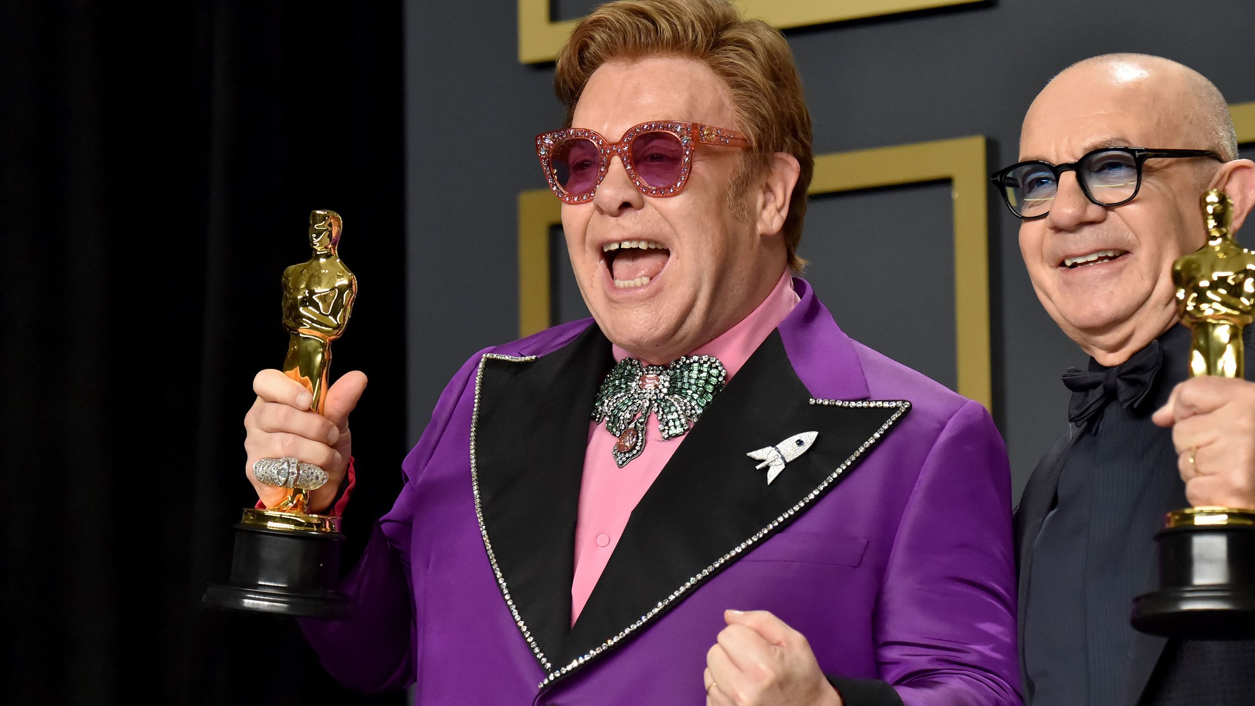 John and Taupin hold the Oscars they won for best original song in 2020. They won for "(I'm Gonna) Love Me Again" from the John biopic "Rocketman."