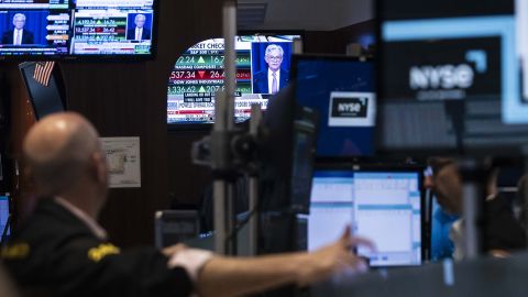 A screen shows a press conference with Jerome Powell, the Chair of the Federal Reserve of the United States, following news about the Federal Reserve decision to raise interest rates by half a percentage point on the floor of the New York Stock Exchange on May 4, 2022.