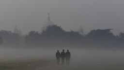 People walks through the dense smog in Kolkata, India, 15 December, 2021. Today's AQI (Air Quality Index) level in Kolkata is 278. Indo-Gangetic plain cities, including Delhi, Lucknow, Patna and Kolkata, accounted for more than 43% deaths due to pollution from PM2.5 concentrations according to an Indian media report.    (Photo by Indranil Aditya/NurPhoto via Getty Images)