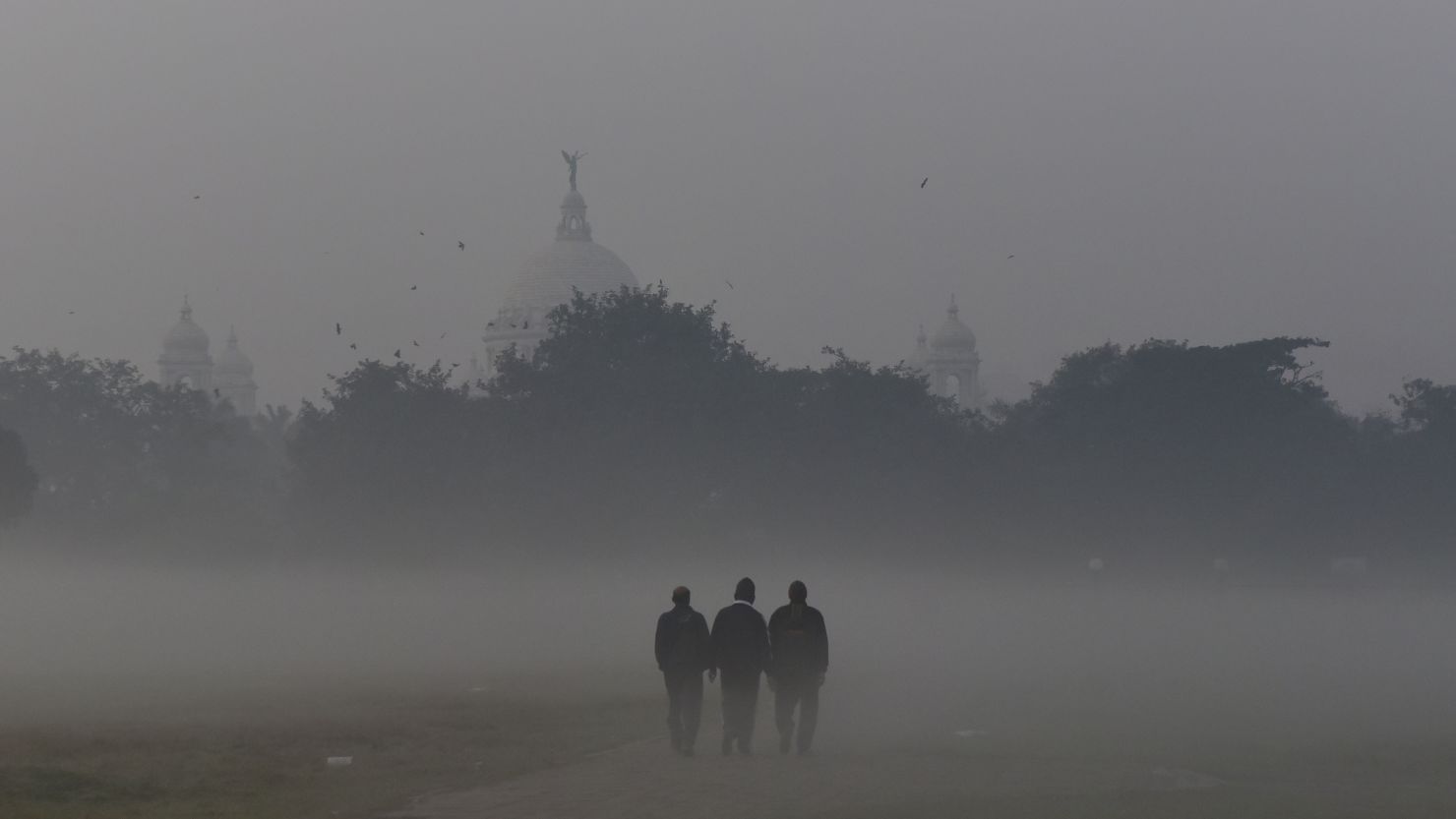 People walks through the dense smog in Kolkata, India, 15 December, 2021. 