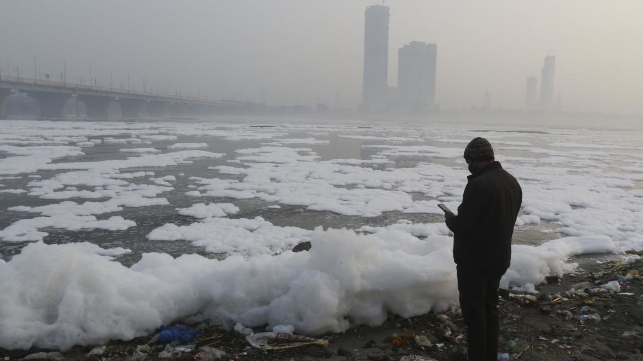 A thick later of toxic foam floats on the Yamuna River on January 24, 2022 in New Delhi, India.