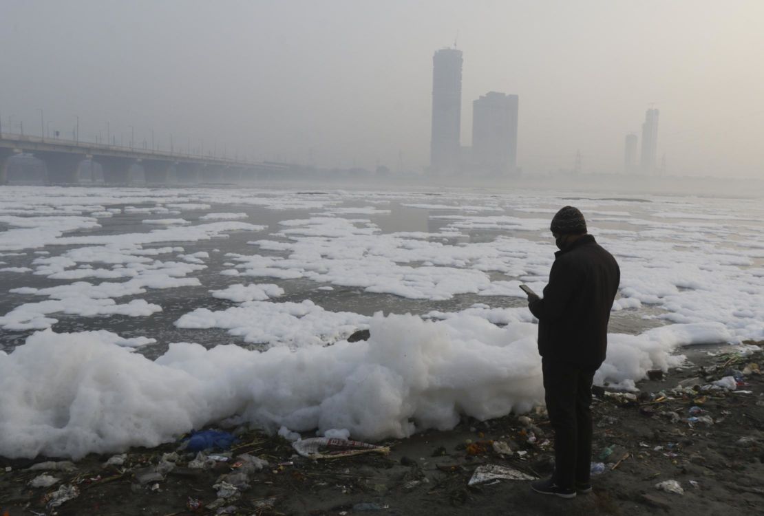 A thick later of toxic foam floats on the Yamuna River on January 24, 2022 in New Delhi, India. 