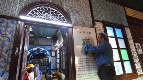 A man cleans a plaque at the Ghriba synagogue in the Tunisian resort island of Djerba on Tuesday, on the eve of the annual Jewish pilgrimage to the synagogue. Dating back to Roman times and once numbering 100,000 people, the Jewish community in Tunisia has shrunk to a mere 2,000 after fear, poverty and discrimination drove waves of emigration after the creation of Israel in 1948. There are more than 1,200 Jews in Djerba. 