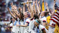 LYON, FRANCE - JULY 07: (EDITORS NOTE: Image has been digitally enhanced.) Megan Rapinoe of the USA lifts the FIFA Women's World Cup Trophy following her team's victory in the 2019 FIFA Women's World Cup France Final match between The United States of America and The Netherlands at Stade de Lyon on July 07, 2019 in Lyon, France. (Photo by Alex Grimm/Getty Images)