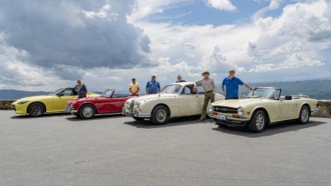 L-R: Peter Valdes-Dapena with a 2023 Nissan Z; Mark Valdes-Dapena with his 1964 Triumph TR4; Jonathan Valdes-Dapena; Andres Valdes-Dapena with his 1964 Jaguar Mark 2; Dan Valdes-Dapena; Carlos Valdes-Dapena with his 1970 Triumph TR6.