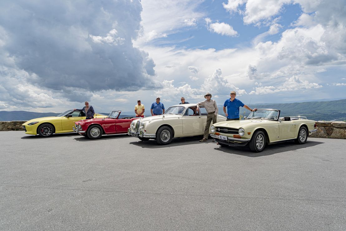 L-R: Peter Valdes-Dapena with a 2023 Nissan Z; Mark Valdes-Dapena with his 1964 Triumph TR4; Jonathan Valdes-Dapena; Andres Valdes-Dapena with his 1964 Jaguar Mark 2; Dan Valdes-Dapena; Carlos Valdes-Dapena with his 1970 Triumph TR6.