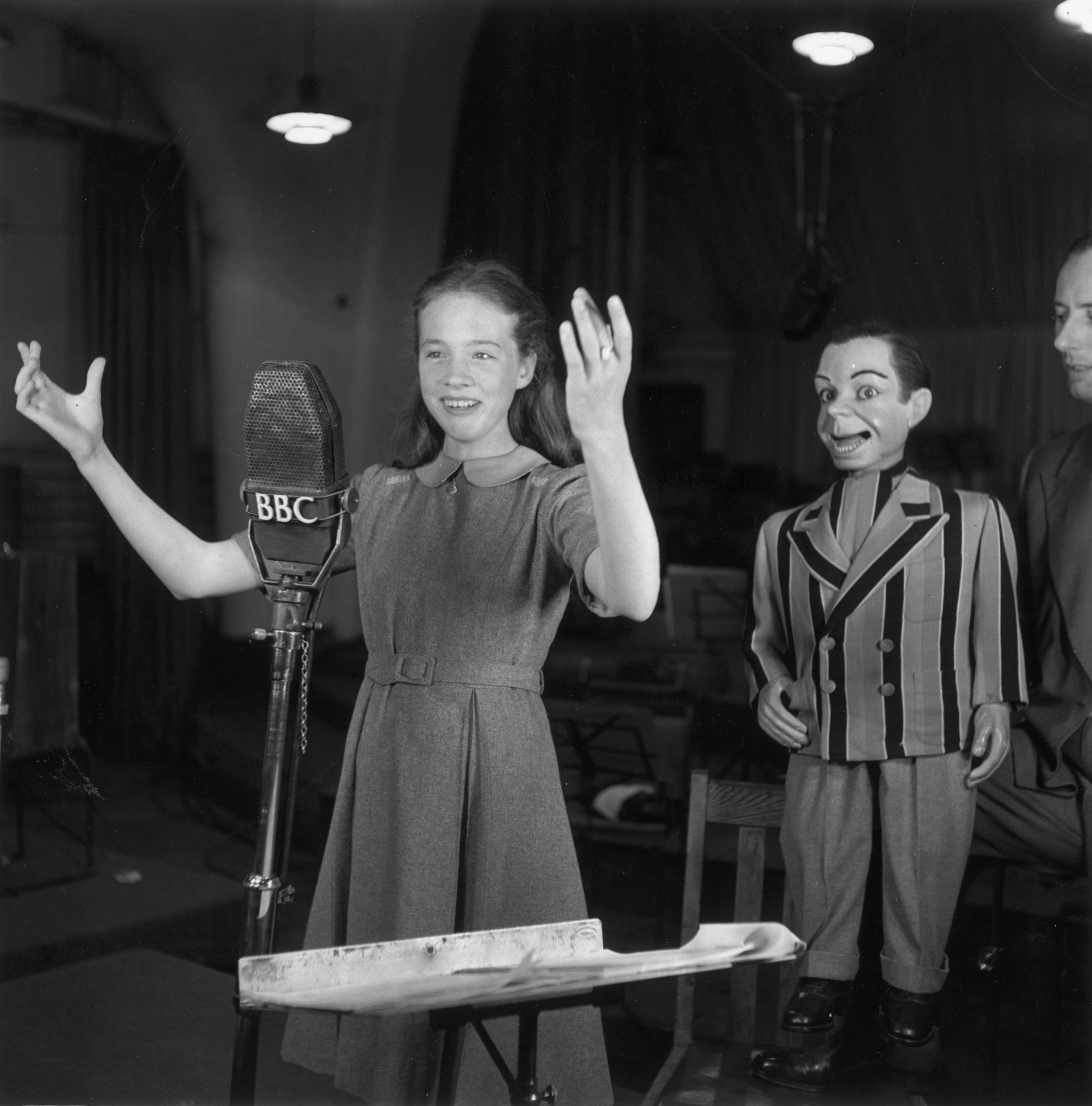 Andrews works with ventriloquist Peter Brough and his dummy Archie Andrews on the BBC radio show 'Educating Archie' in 1950.