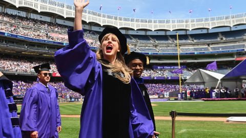 Taylor Swift waves at graduating students during New York University's commencement ceremony for the class of 2022.