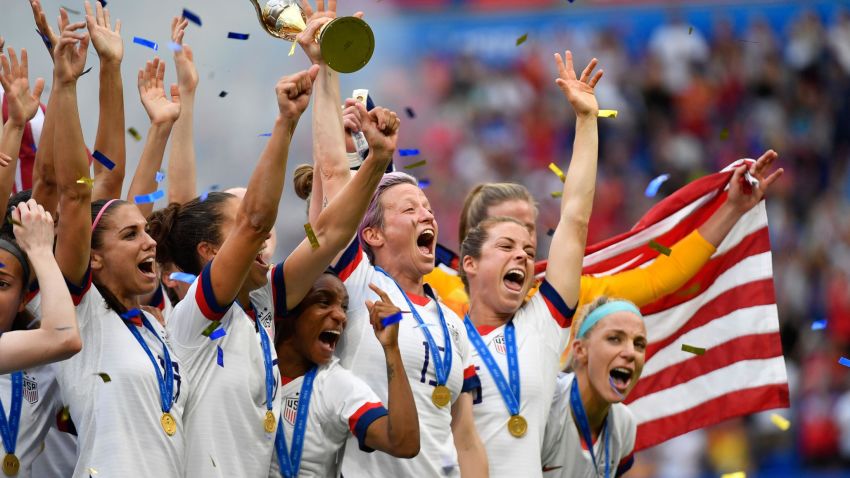 USA's players including forward Megan Rapinoe (C) celebrate with the trophy after the France 2019 Womens World Cup football final match between USA and the Netherlands, on July 7, 2019, at the Lyon Stadium in Lyon, central-eastern France. (Photo by Philippe DESMAZES / AFP)        (Photo credit should read PHILIPPE DESMAZES/AFP via Getty Images)