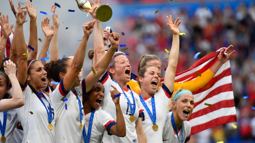 USA's players including forward Megan Rapinoe (C) celebrate with the trophy after the France 2019 Womens World Cup football final match between USA and the Netherlands, on July 7, 2019, at the Lyon Stadium in Lyon, central-eastern France. (Photo by Philippe DESMAZES / AFP) (Photo credit should read PHILIPPE DESMAZES/AFP via Getty Images)