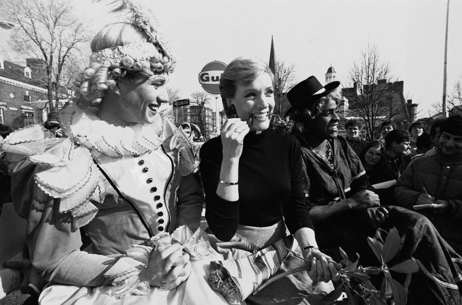 Andrews clenches a flower in her teeth as she rides through Harvard Square in Cambridge, Massachusetts, in 1983. She was on her way to accepting the Hasty Pudding Woman of the Year award.
