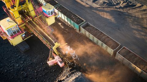 Workers loading coal into train cars at a mine in the Krasnoyarsk region of Siberia, Russia.