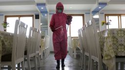 FILE - An employee of Pyongyang Dental Hygiene Products Factory disinfects the floor of a dining room as the state increased measures to stop the spread of illness in Pyongyang, North Korea on May 16, 2022.  North Korea on Wednesday, May 18, reported 232,880 new cases of fever and another six deaths as leader Kim Jong Un accused officials of "immaturity" and "slackness" in handling the escalating COVID-19 outbreak ravaging across the unvaccinated nation. (AP Photo/Cha Song Ho, File)