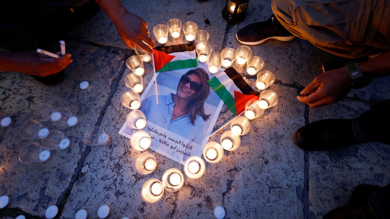 People light candles during a vigil in memory of Abu Akleh.