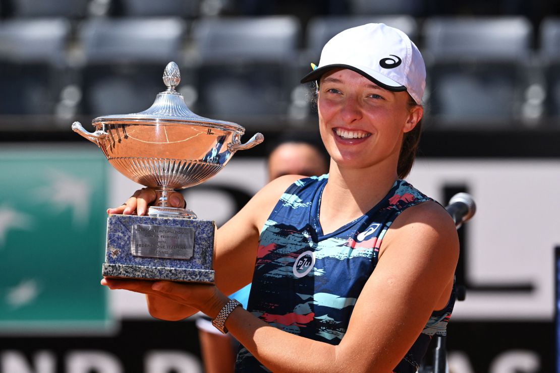 Swiatek poses with the winner's trophy after defeating Tunisia's Ons Jabeur to win the final of the Women's WTA Rome Open tennis tournament on May 15, 2022. 