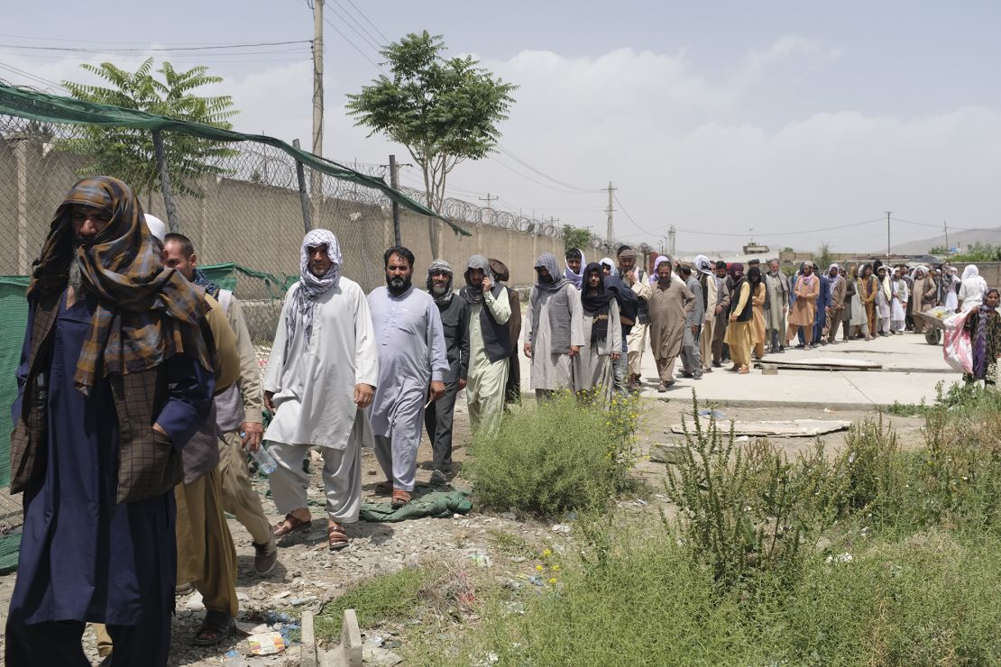 Men line up at the World Food Programme aid distribution site in Kabul's Khwaja Rawash neighborhood. 