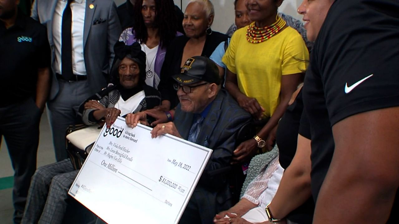 Mitzen presented the donation to three survivors of the massacre, including Lessie Benningfield Randle, left, and Hughes Van Ellis, right.