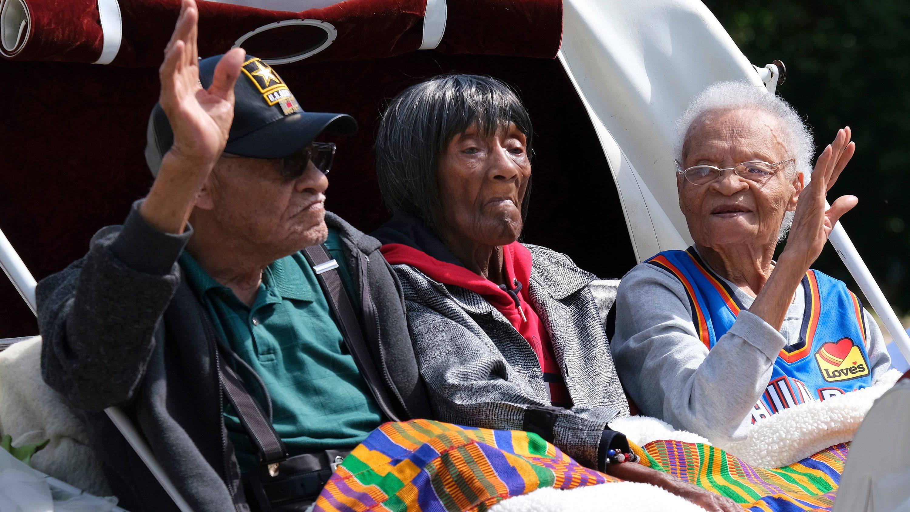 Tulsa race massacre survivors, Hughes Van Ellis, Lessie Randle and Viola Fletcher ride in a carriage at the front of the Black Wall St. Memorial on March 28, 2021.