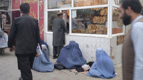 Women beg for bread outside a Kabul bakery.