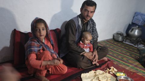 Waliullah and his family sit down for dinner in their home on the outskirts of Kabul.