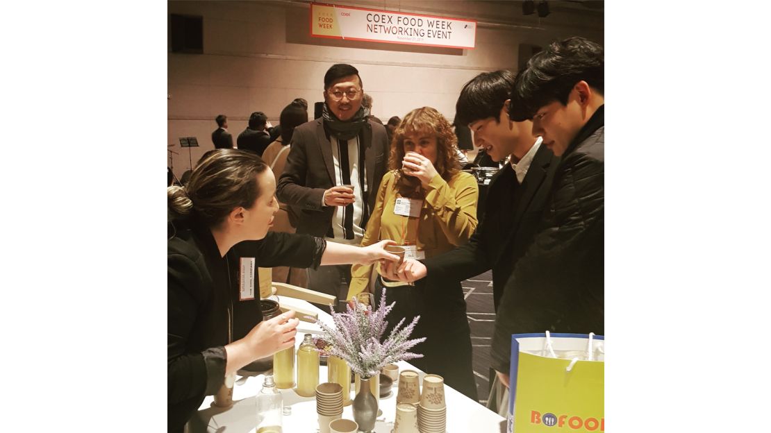 Participants in a The Sool Company tasting session hold up their glasses.