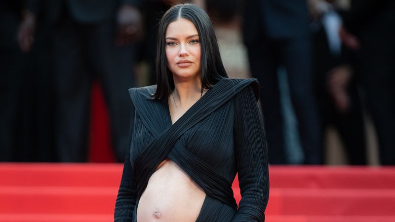 Adriana Lima shows off baby bump on Cannes red carpet