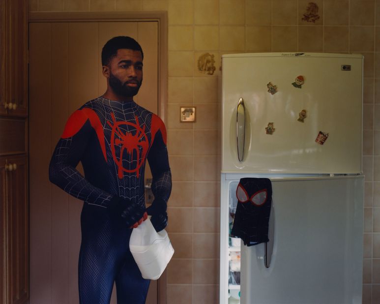 Spiderman stands in the kitchen, taking a container of milk from the fridge. Scroll through the gallery to see more images from Thurstan Redding's "Kids of Cosplay" series. 