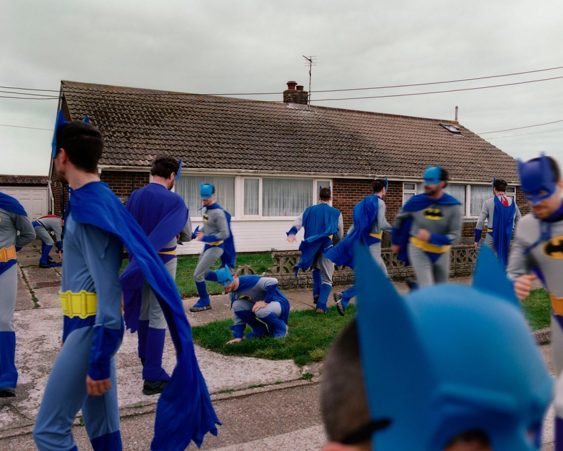 Batmen pictured outside a small brick bungalow.