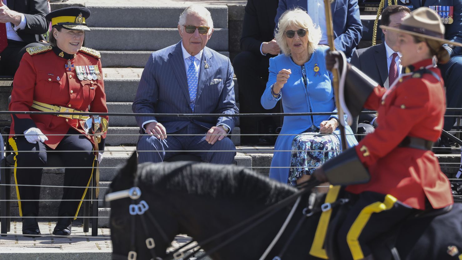 Prince Charles and Camilla, Duchess of Cornwall watch a parade by the Royal Canadian Mounted Police.