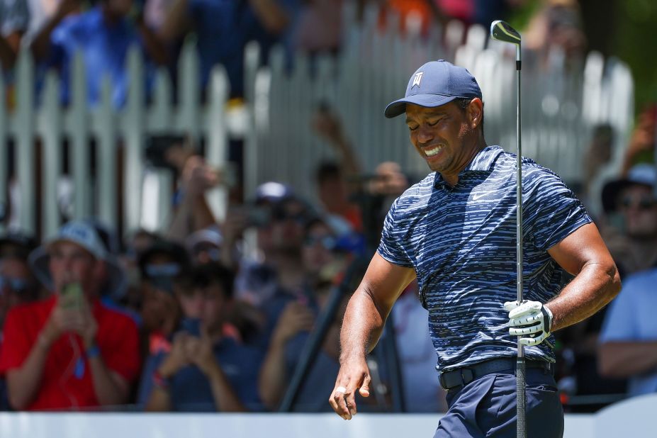 Tiger Woods reacts after his shot from the eighth tee during the first round.