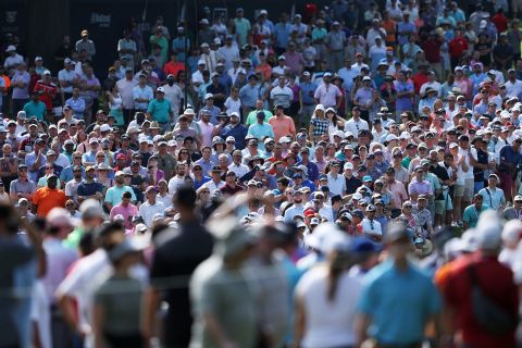 Fans watch on the 14th hole during the first round.