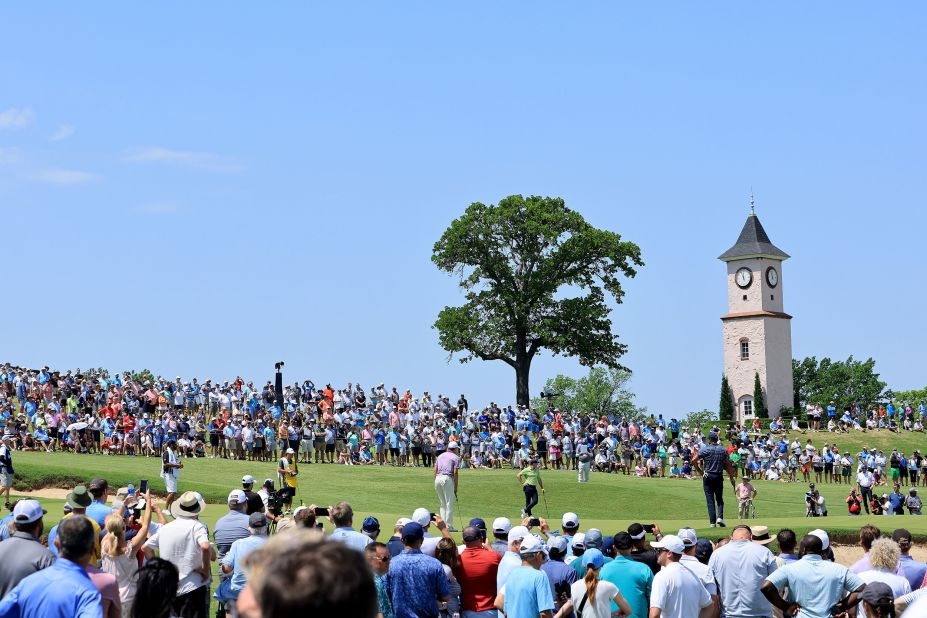 Jordan Spieth, Rory McIlroy and Tiger Woods stand on the fourth green.