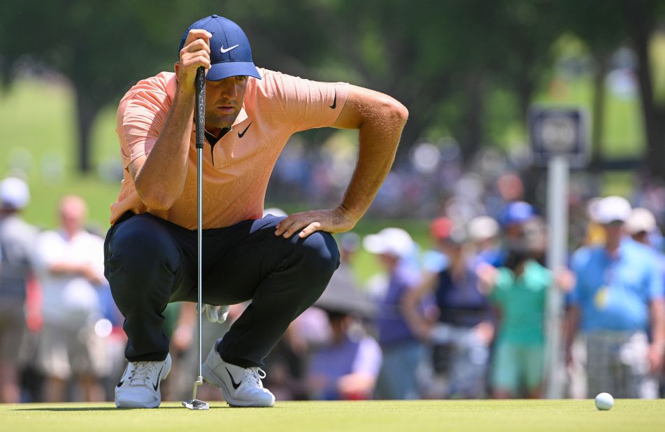 Scottie Scheffler lines up a putt on the second green.