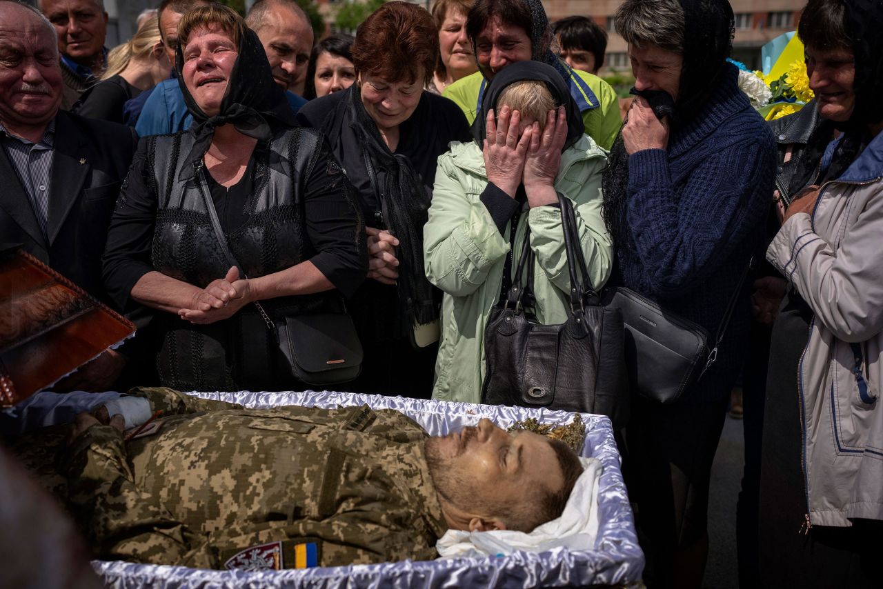Relatives react next to the body of Ukrainian military serviceman Pankratov Oleksandr during his funeral in Lviv, Ukraine, on Saturday, May 14. <a href="https://www.cnn.com/interactive/2022/05/world/ukraine-war-photographers-cnnphotos/" target="_blank">See the photos that have defined the war in Ukraine</a> since Russia invaded the country.