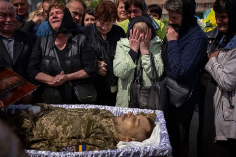 Relatives react next to the body of Ukrainian military serviceman Pankratov Oleksandr during his funeral in Lviv, Ukraine, on Saturday, May 14. <a href=