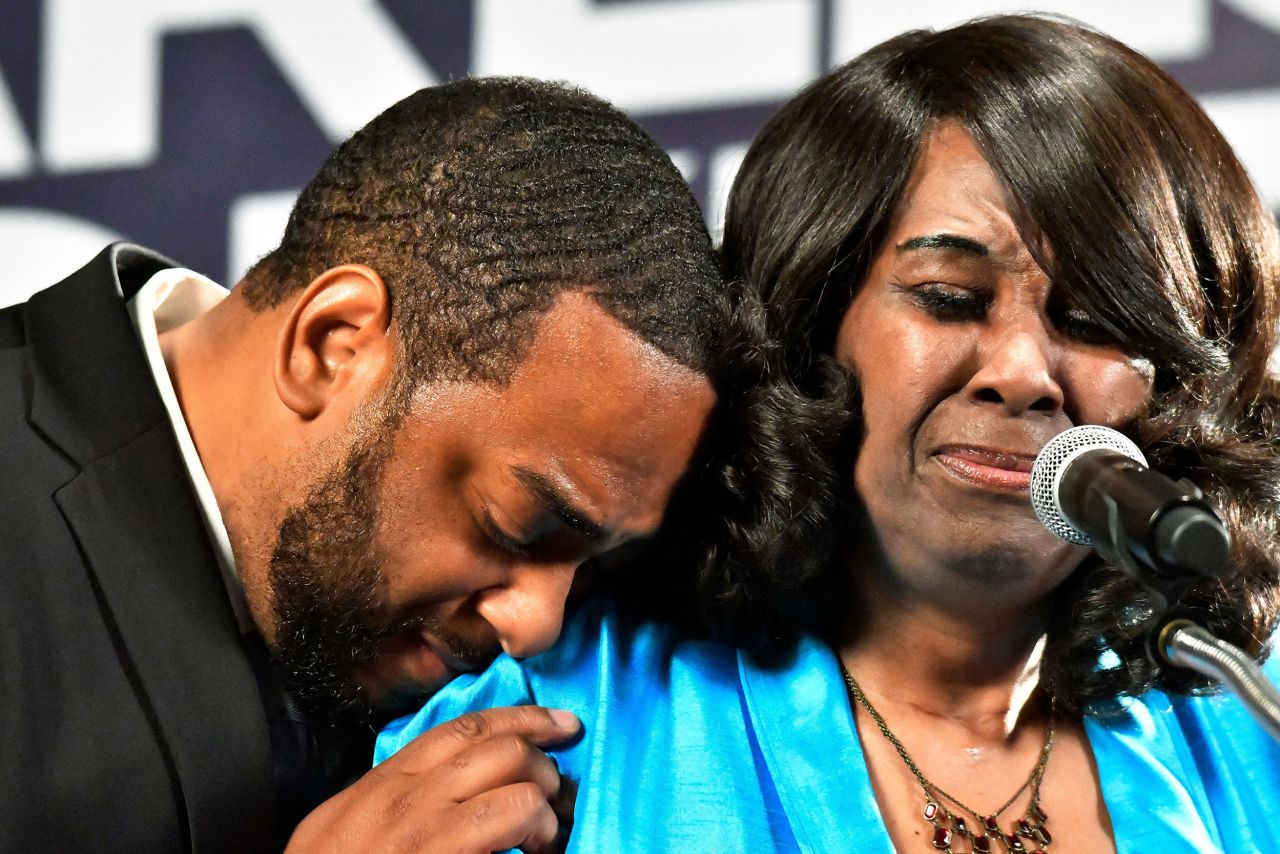 Democrat Charles Booker, left, hugs his mother, Earletta Hearn, as she speaks in Louisville, Kentucky, to a group of supporters following<a href="https://www.cnn.com/election/2022/results/kentucky/democratic-primaries/senate" target="_blank"> her son's victory in the state's primary</a> on Tuesday, May 17.