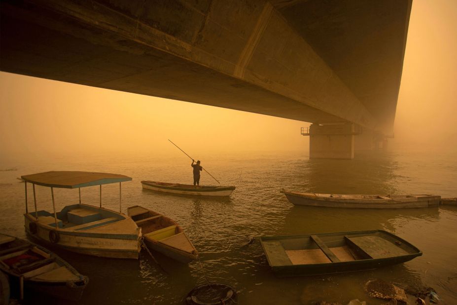 A fisherman paddles his boat during a sandstorm in Iraq's southern city of Basra on Monday, May 16.
