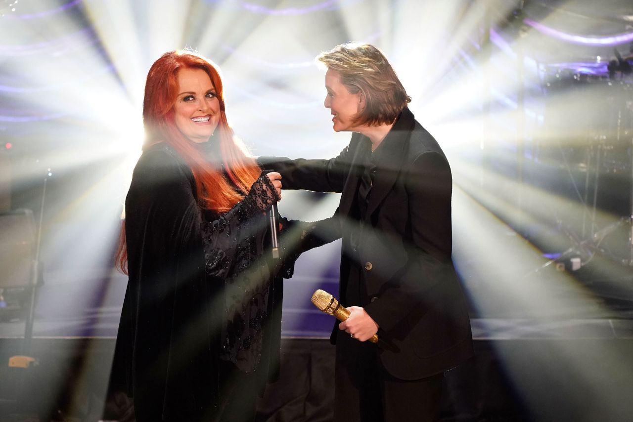 From left, country artists Wynonna Judd and Brandi Carlile sing "The Rose" during a <a href="https://www.cnn.com/2022/05/15/entertainment/naomi-judd-public-memorial/index.html" target="_blank">public memorial held for Judd's mother,</a> country music star <a href="https://www.cnn.com/2022/04/30/entertainment/gallery/naomi-judd-life-in-pictures/index.html" target="_blank">Naomi Judd,</a> on Sunday, May 15, at Ryman Auditorium in Nashville, Tennessee. The singer and songwriter <a href="https://www.cnn.com/2022/05/12/entertainment/naomi-judd-cause-of-death/index.html" target="_blank">died by suicide in April at the age of 76.</a> At the memorial Judd announced that to honor her mother, she planned to continue on the tour they were supposed to do together.